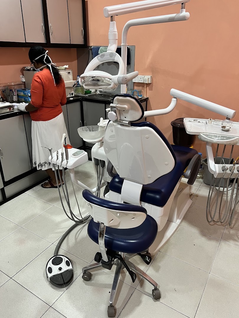 Dental chair and equipment inside a peach coloured treatment room